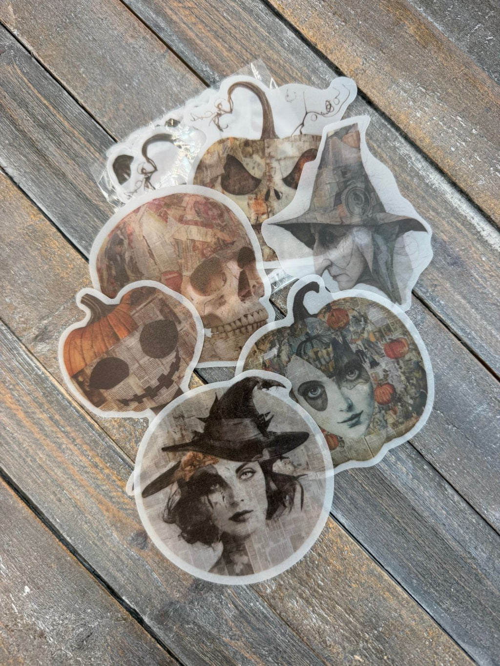 Vellum After Dark Paper Bites — skull, jack-o-lantern and witch vellum die cuts fanned out on wood